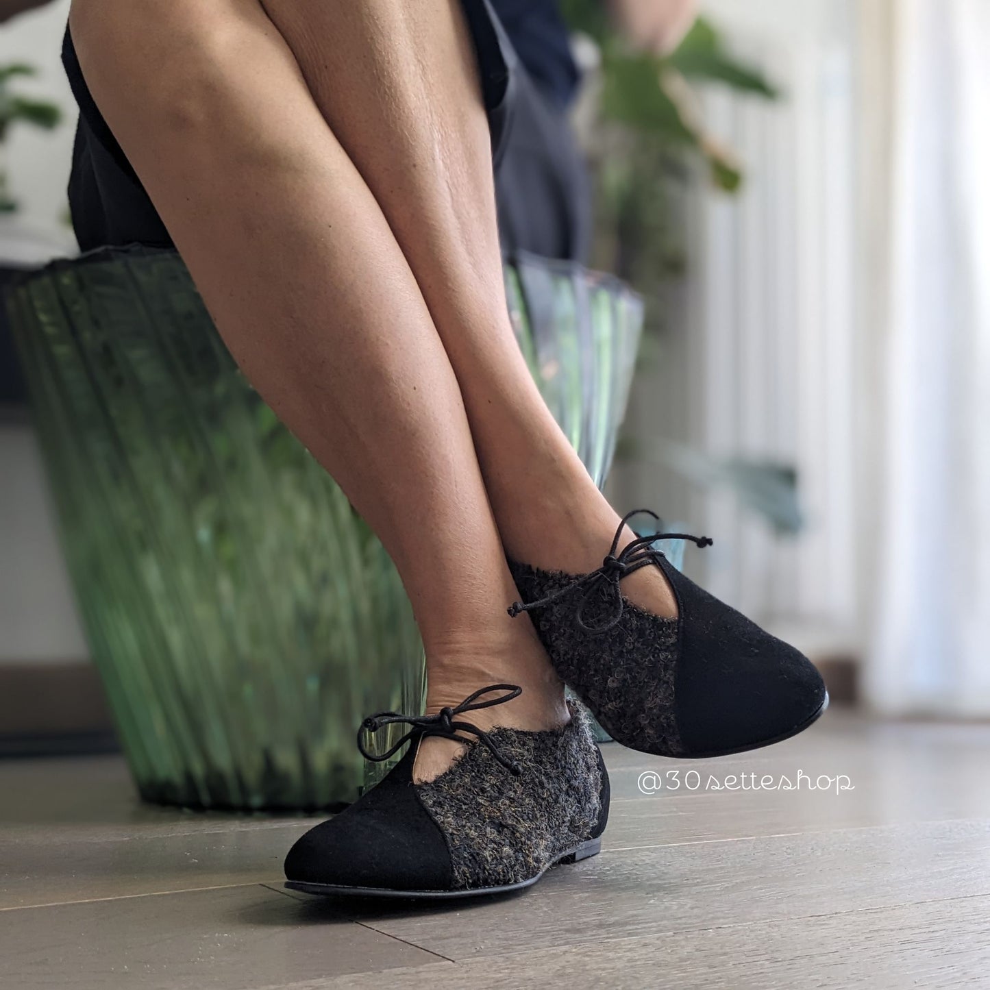 Gilda Ballerina bicolore in camoscio nero e tessuto con punta affusolata, laccio e scollo a v sul dorso del piede. Zeppa interna di 2 cm sul tallone a cui sommare il tacco esterno di 0,8 cm