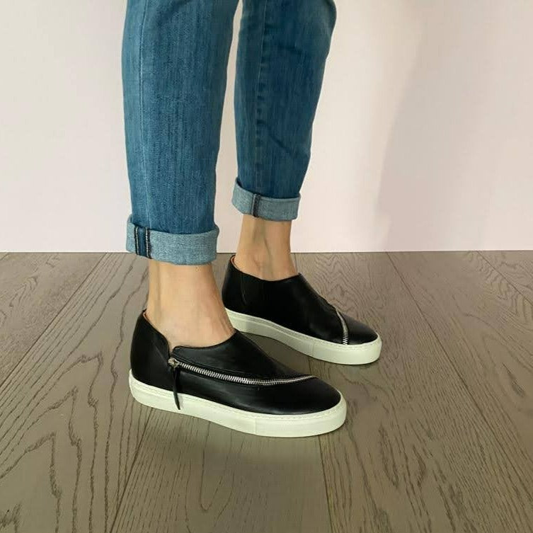 SNEAKERS SLIP-ON NERA CON CERNIERA. TOMAIA IN MORBIDISSIMO NABUK INGRASSATO NERO, DALLA FORMA LINEARE E CONTEMPORA GRAZIE ALLA LUNGA CERNIERA IN ACCIAIO CHE TAGLIA LA TOMAIA. FONDO A CASSETTA IN GOMMA BIANCA LEGGERISSIMA. FUSSBETT ESTRAIBILE RICOPERTO IN PELLE CON RIALZO INTERNO SUL TALLONE DI 3 CM. CALZATA COMODA. SE HAI DUBBI, CONTATTACI VIA SMS O WHATSAPP AL 351/8950405 TI CONSIGLIEREMO NELLA SCELTA. TOMAIA - FODERA - SOTTOPIEDE IN PELLE 100%. PELLAMI ITALIANI DI QUALITÀ. PRODOTTO IN ITALIA, MARCHE